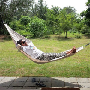 A women relaxing in a hammock.