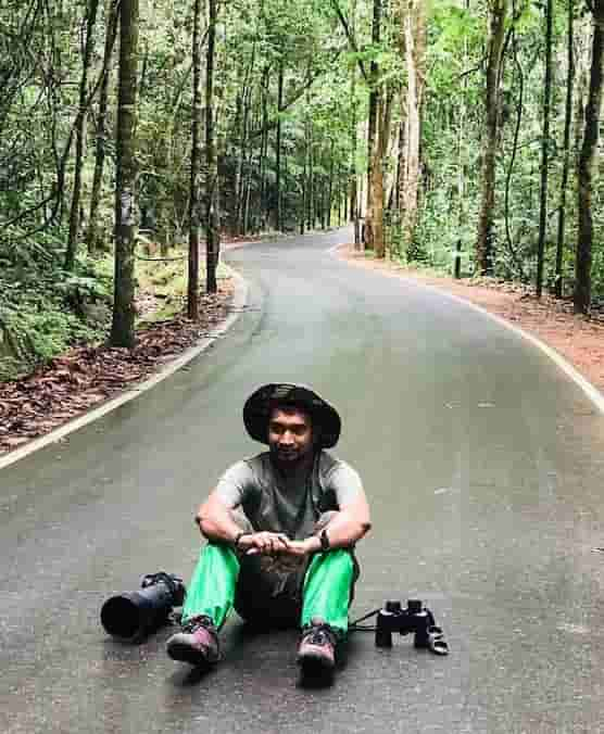 a photographer sitting on the road.