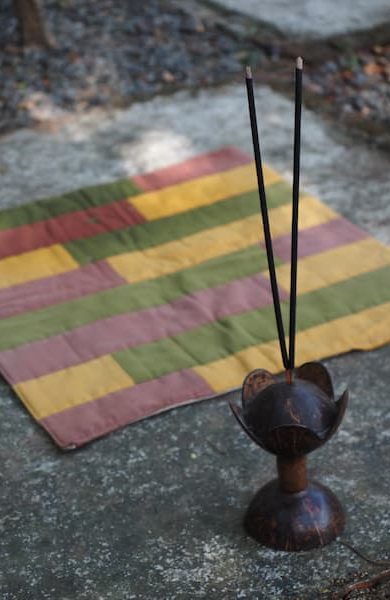 a coconut shell incense stick holder